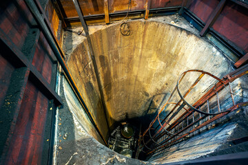 A shaft with a ladder, typically used for drainage purposes. This type of inspection or access shaft is designed to provide access for maintenance or inspection of drainage systems.