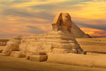 The Great Sphinx and Pyramid against colorful sunset sky in Giza, Cairo, Egypt