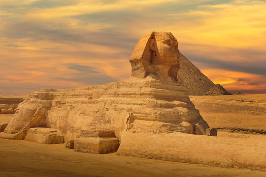 The Great Sphinx and Pyramid against colorful sunset sky in Giza, Cairo, Egypt