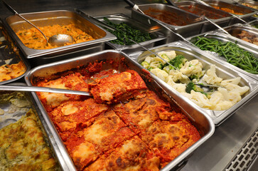 catering service presents abundant food in steel serving trays