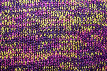 Close-up of knitted pattern in yellow and purple colours