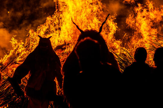 Silhouette of devil monster in front of a huge fire