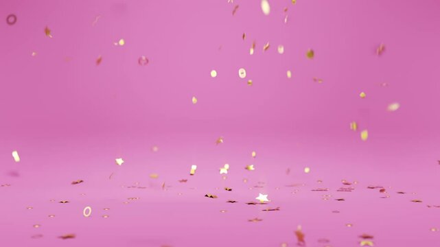 Falling golden confetti on the floor of the pink studio background