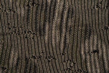Close-up of intricately woven material with intermingling light and dark threads, offering a sophisticated texture perfect for textile applications.