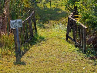 Gated passage between fields with posted No Trespassing sign