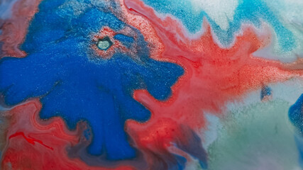 Spilling paint. Shimmer water. Defocused red blue color chemical liquid marble texture fluid bubble...
