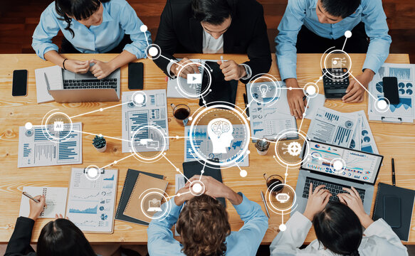 A dynamic team engages in data analysis and business strategy planning, utilizing advanced technology and collaborative tools to foster innovation in the workspace. Amity - Powered by Adobe