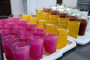 Multicolored tasty liquid in glasses. Catering.