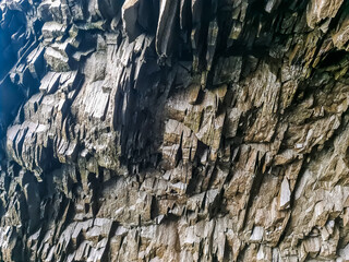 Basalt rock formations creating a textured natural wall in Iceland