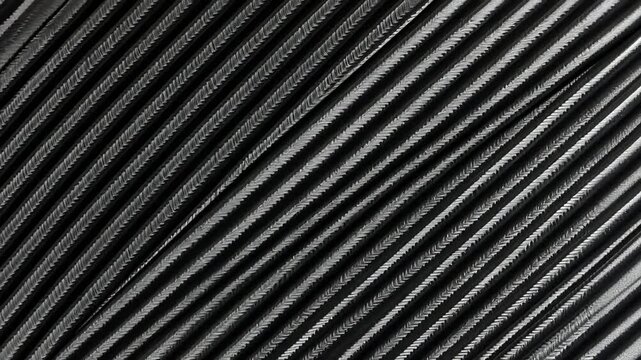 Close-up view of textured black surface with parallel lines creating a modern, abstract design
