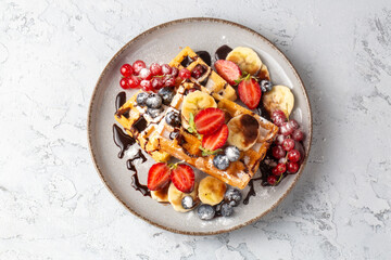 Delicious fresh baked belgian waffles with berries and fruit