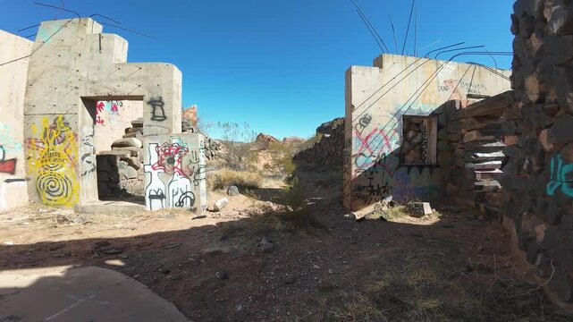 Virgin River Gorge- Hurricane, Utah, USA - February 10, 2025: Aerial-FPV-Flying through Babylon house graffiti covered ruins to Stormont silver mill ruins