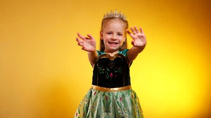 A radiant princess, arms outstretched, waving hello. Joyful child in a shimmering dress, welcoming the world. A little queen, radiating happiness against a vibrant backdrop. A young model as a queen, 