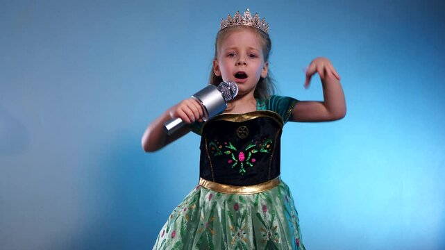 A little princess, voice soaring, a captivating performance. The Queen sings into the microphone and dances. Karaoke. Emerald gown, sparkling crown, a tiny starlet takes the stage. Hands clasped 
