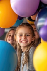 Obraz premium Smiling caucasian young girl surrounded by colorful balloons at a celebration