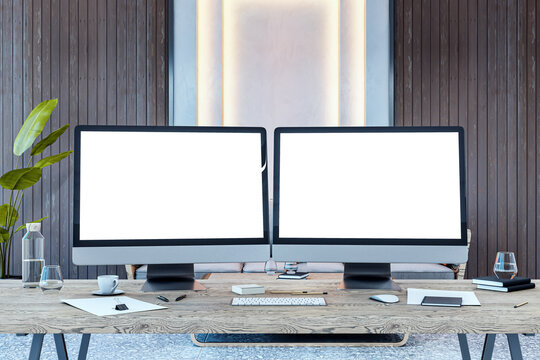 Dual desktop computer screens with blank mockups on a wooden desk in a modern office interior. 3D Rendering