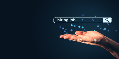 Hiring job search bar concept with a human hand presenting a glowing online recruitment interface on a dark background.