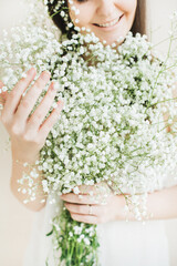 Woman Holding Bouquet of Baby's Breath Flowers
