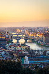 Florence, Italy - skyline view from Piazzale Michelangelo over Arno river with Ponte Vecchio at sunset.