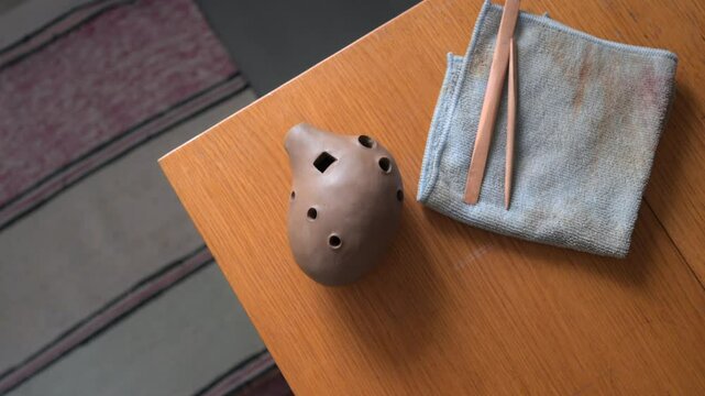 Handcrafted Ocarina Artistically Created with Essential Tools on a Beautiful Wooden Table