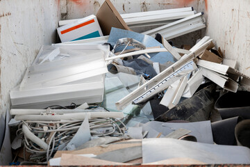 orange container filled with construction waste. container for construction waste. throwing out...