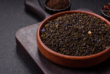 Dry green tea with soursop piece, knapweed petals in bowl