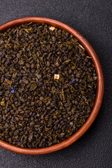 Dry green tea with soursop piece, knapweed petals in bowl