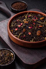 Dry tea mix blend black, green and flower petals in bowl