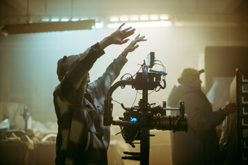 A female director at work on the set. The director works with a band or with a speaker during the...