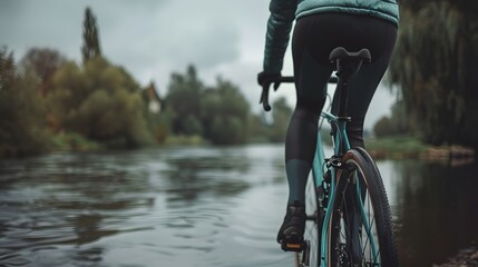 Cycling by the water autumnal landscape rear view