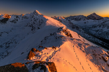 Sunset Over Snowy Mountain Ridge
