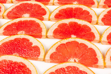 Grapefruit red juicy slices background. top view.