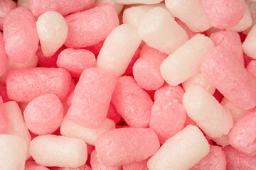 Pink and white box filler as a background. Top view.