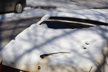 A vehicle stuck in snowy weather, useful for winter or travel-related scenes.
