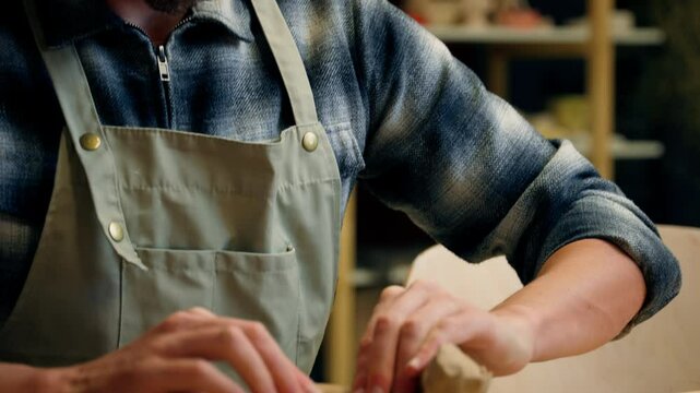 Potter sculptor Caucasian man guy male artist decorator craftsman process sculpt plate clay modeling shape eco material handmade ceramics crockery create stoneware craft in pottery workshop art studio