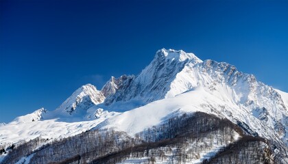 Obraz premium majestic mountain peak covered in snow under a clear blue sky a picturesque winter landscape