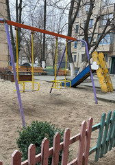 A small playground at the house on the background of kindergarten,