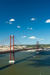 25th of April Bridge and Tagus River. Ponte 25 de Abril Suspension Bridge and Lisbon Skyline. Blue Sky. Portugal