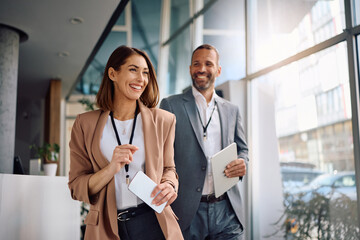 Happy entrepreneur and her colleague at corporate office building.