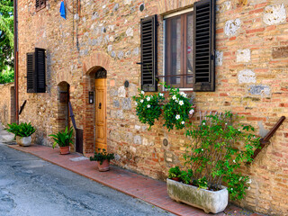 Cozy old street in San Gimignano, Tuscany, Italy. San Gimignano is typical Tuscan medieval town in Italy