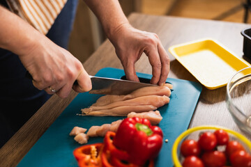 Close Up Of Hand Cutting Meat