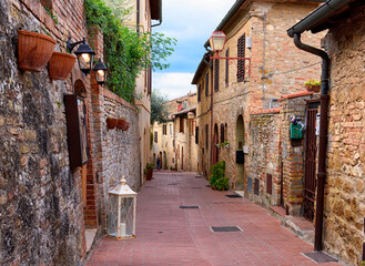 Cozy old street in San Gimignano, Tuscany, Italy. San Gimignano is typical Tuscan medieval town in Italy