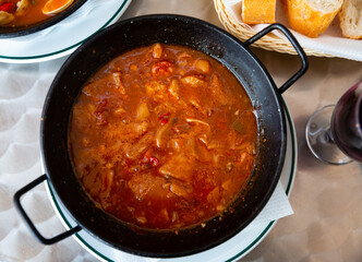 Hot Callos stew - traditional dish of Spanish cuisine. Rich pork tripe broth with vegetables