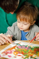 Father and son spend time together painting