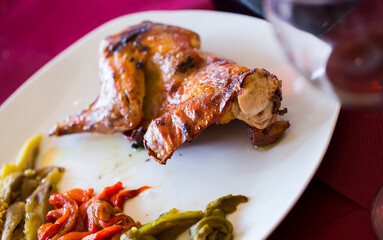 Tasty fried rabbit, served with vegetables at plate, dish of spanish cuisine conejo a la brasa..