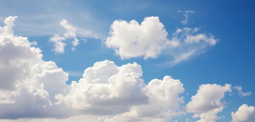 Fototapeta premium Fluffy white cumulus clouds drift across a vibrant blue sky, fluffy, sky