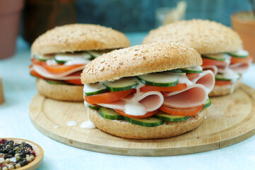 Bun sandwiches with salami and vegetables	