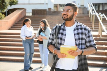 Happy indian male student at the university