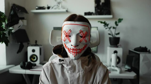 Hooded figure using advanced technology for online anonymity and security. Digital environment highlights cyber protection, encrypted data, network safety, and futuristic hacker workspace.