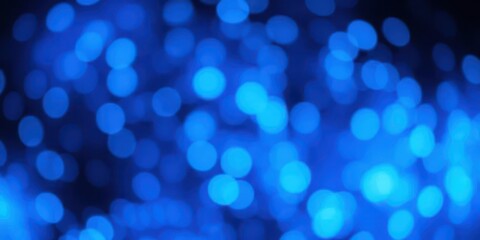 Abstract bokeh background of swirling blue glowing particles, creating a dreamy, ethereal effect, motion, abstract art